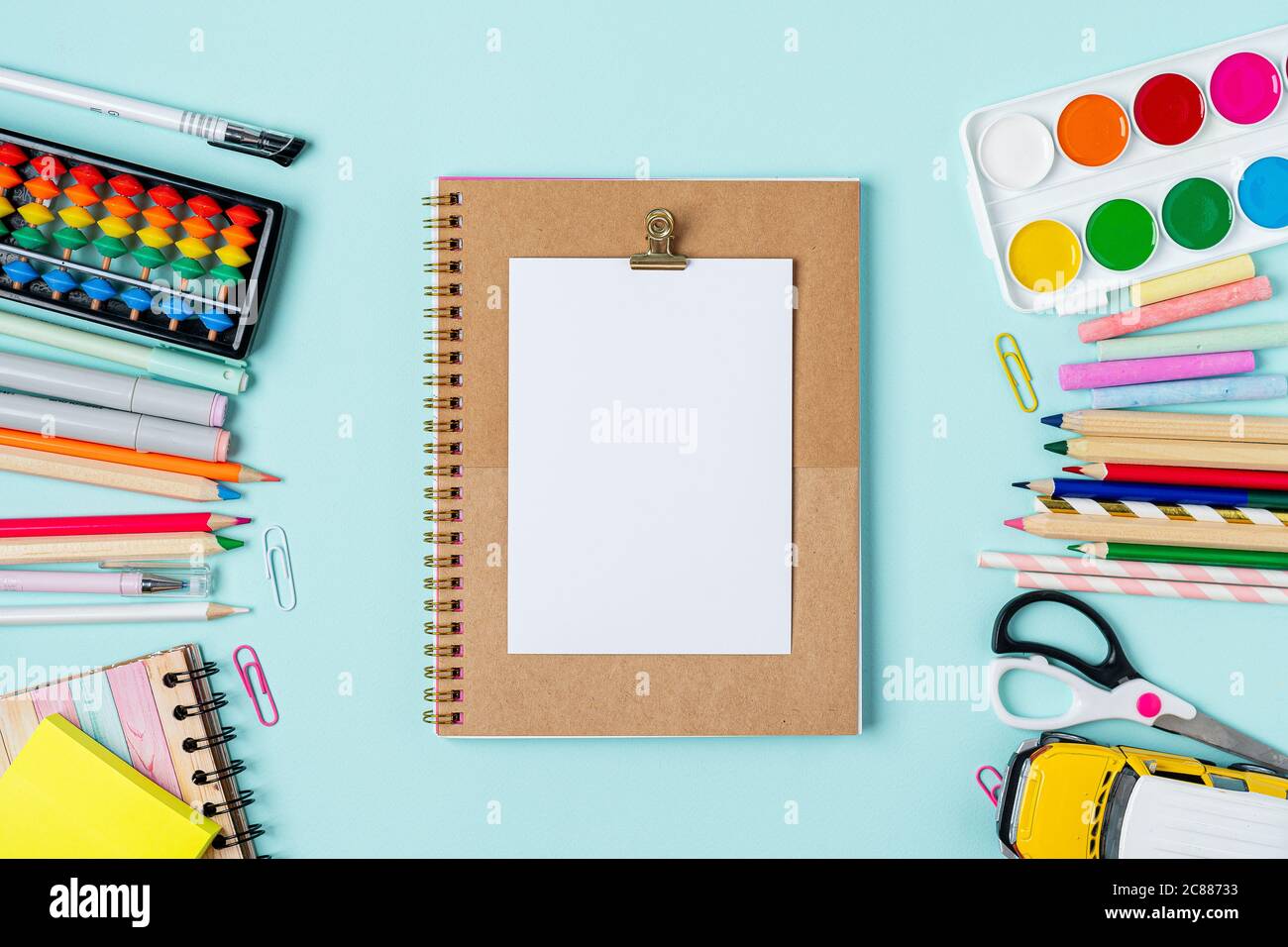 Flat lay of modern bright blue office desktop with school supplies on ...