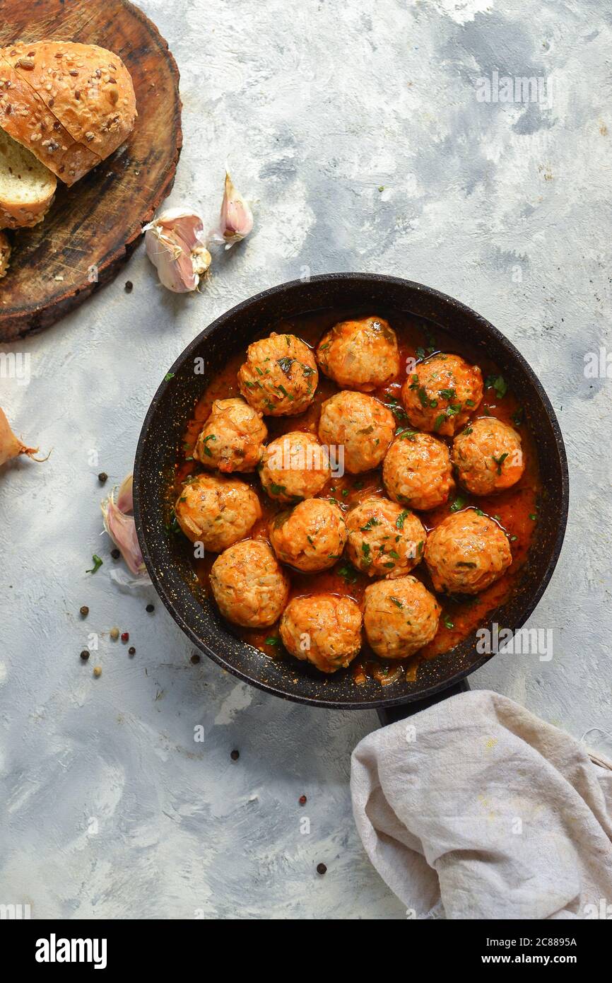 Chicken meatballs in tomato sauce in a pan. Recipe and Step by Step