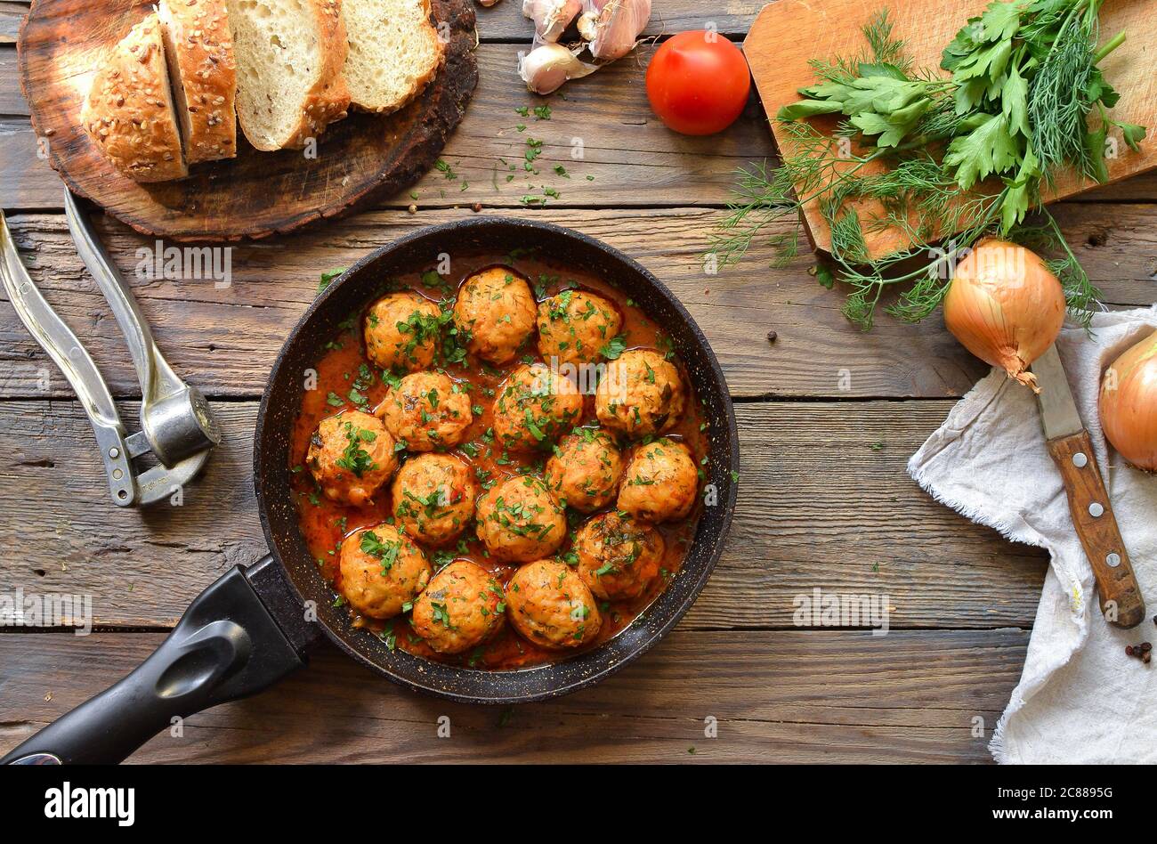 Chicken meatballs in tomato sauce in a pan. Recipe and Step by Step