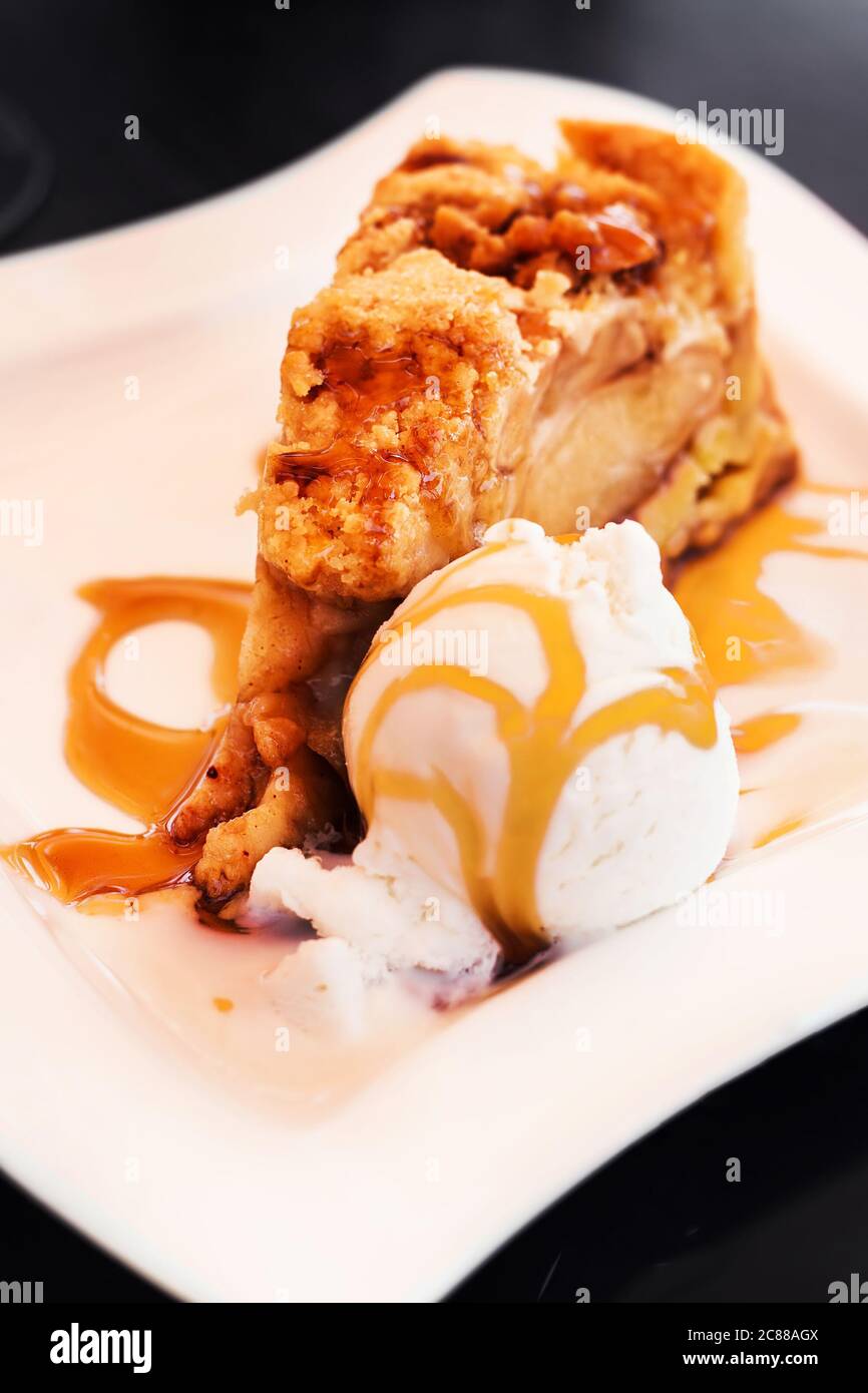 Apple pie served with vanilla ice cream, selective focus Stock Photo