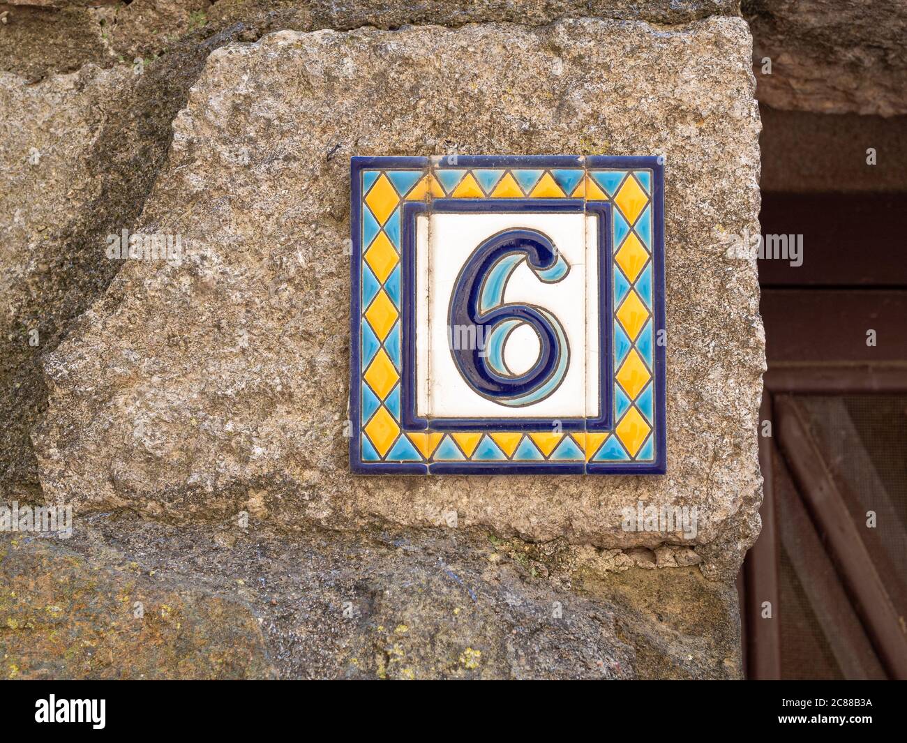 Door sign number 6 tile plate on the wall in the Azulejo style Stock Photo