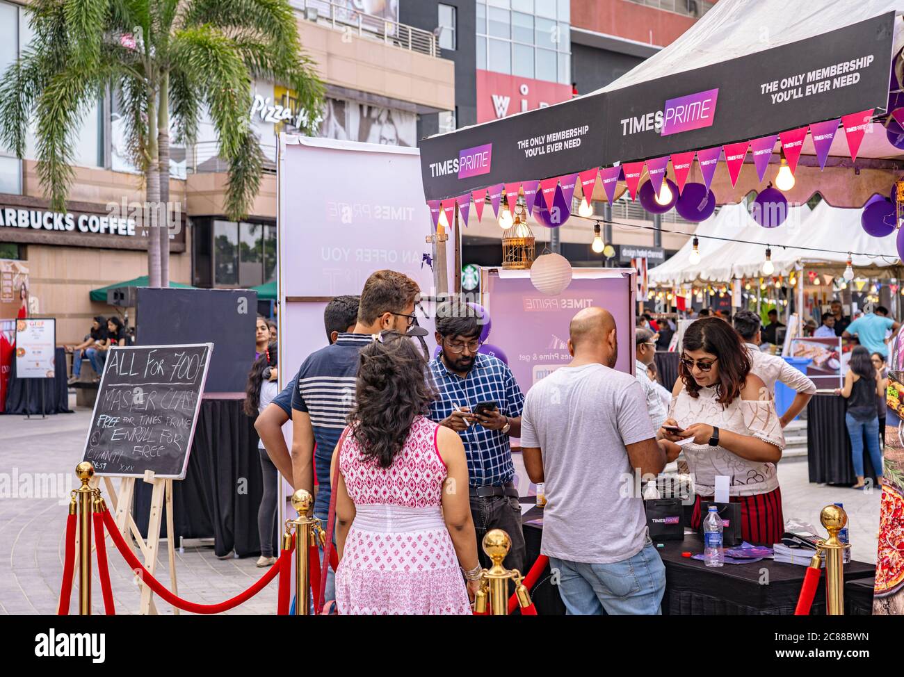 People waiting in line at the registration desk to sign up for a membership at a food festival Stock Photo