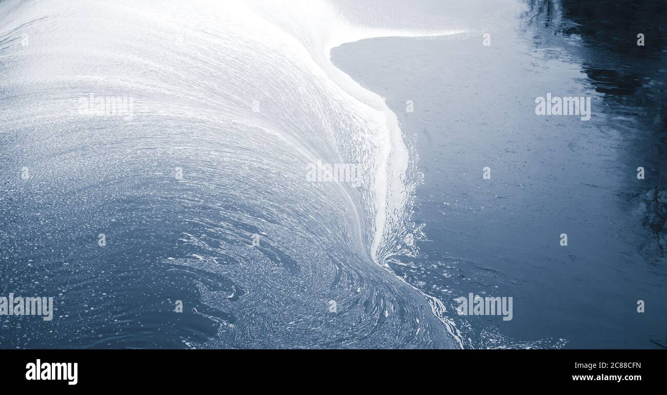 Dark blue water surface with pollution foam. Natural background photo texture Stock Photo