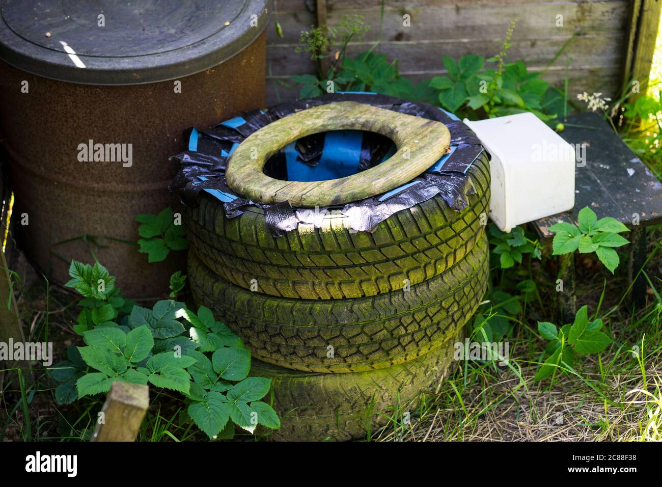 Home made composting toilet made from old tyres.England,UK Stock Photo