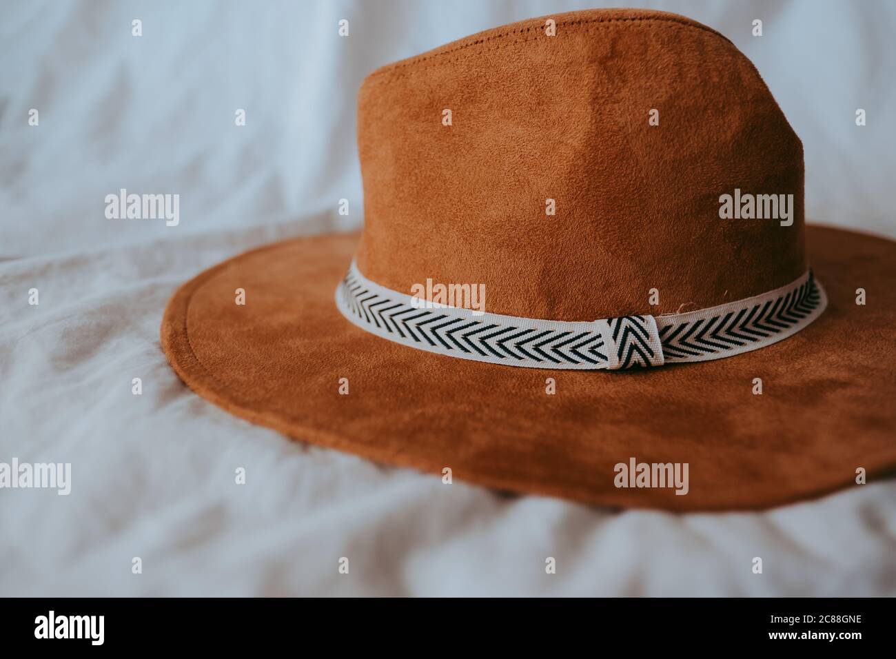 Cowboy hat on a white bed Stock Photo Alamy