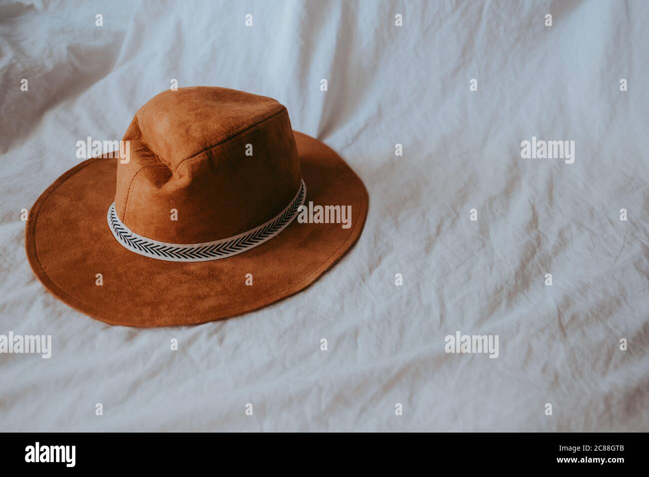 Cowboy hat on a white bed Stock Photo Alamy