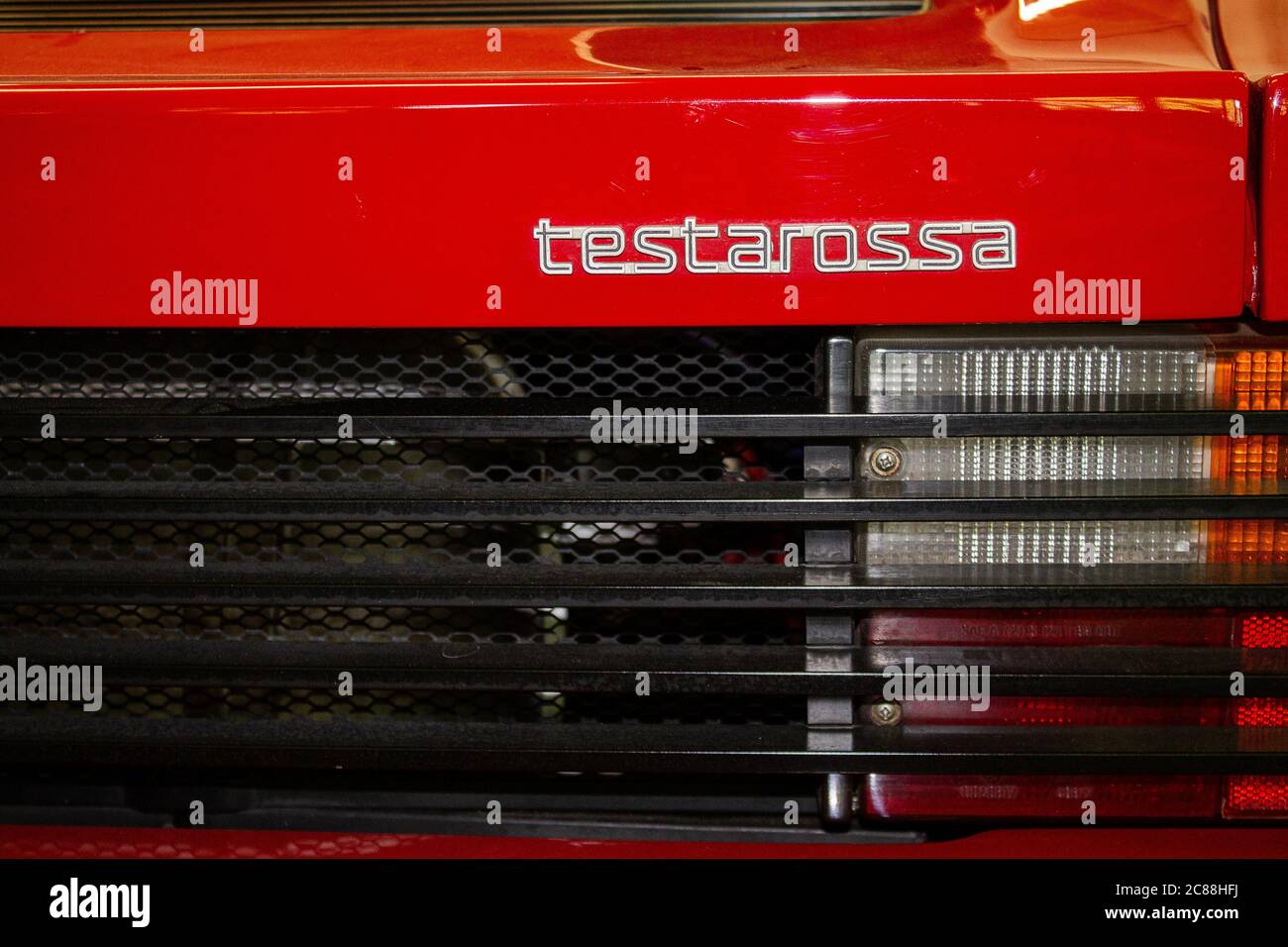 Photo of the original lettering of a Ferrari Testarossa. You can also see a part of the rear lights. Stock Photo