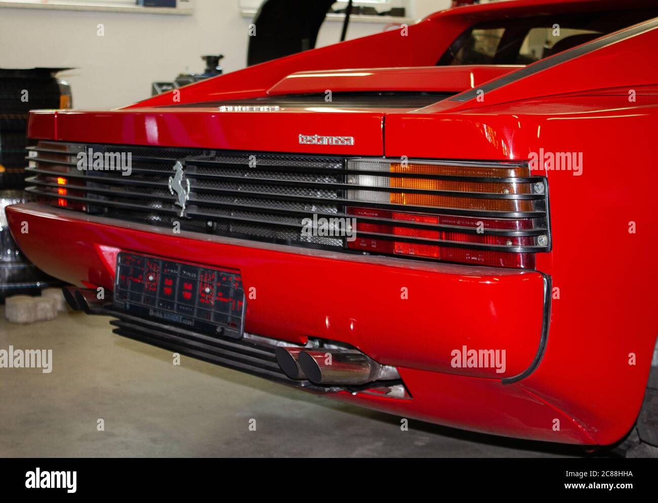 Photo of a Ferrari Testarossa rear section with logo. Photographed from the back right. Stock Photo