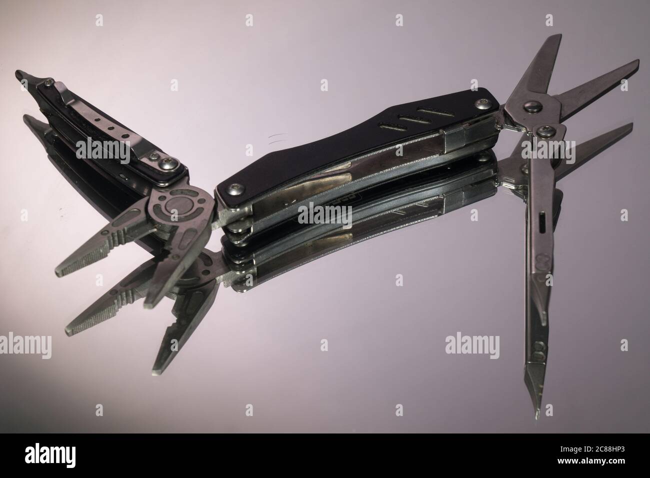 grey swiss knife isolated on white background Stock Photo
