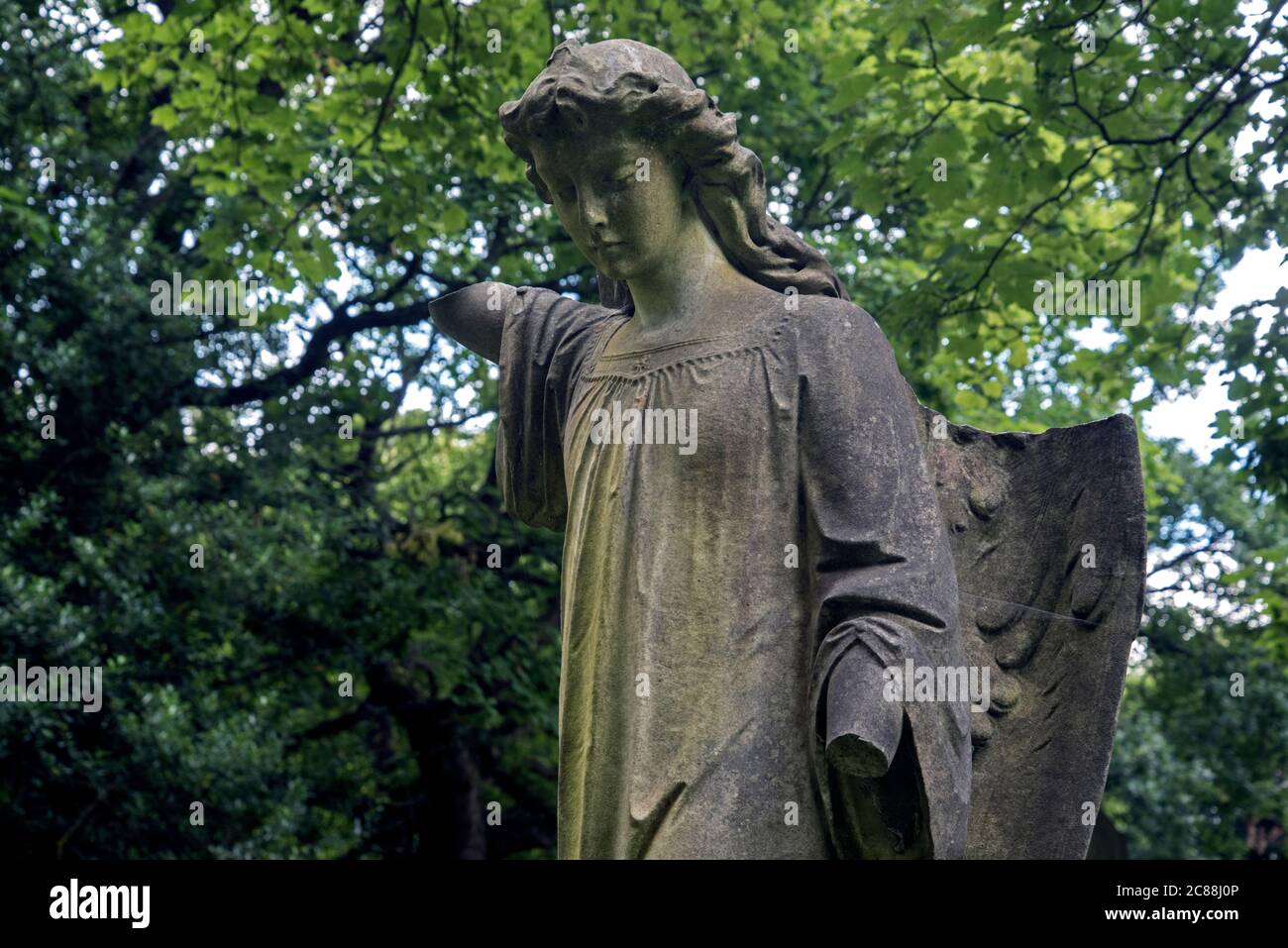 Damaged figure of an angel in the neglected and overgrown Newington Cemetery, Edinburgh, Scotland, UK Stock Photo
