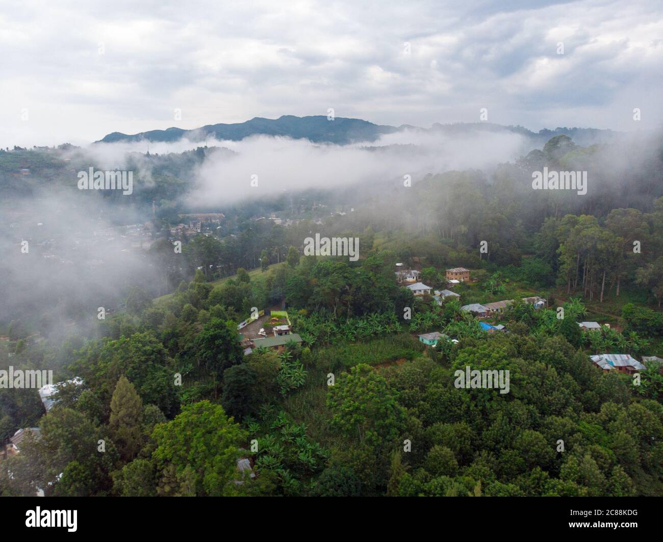 Aerial Drone Shot of Cloudy Misty Foggy Lushoto village in Usambara Mountains. Remote Place in Tanga Province, Tanzania, Africa Stock Photo