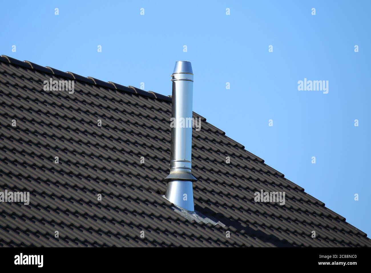 Stainless steel chimney on a new residential home Stock Photo