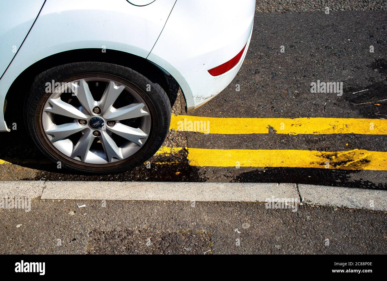 Car illegally parked on double yellow lines, Cardiff, Wales Stock Photo
