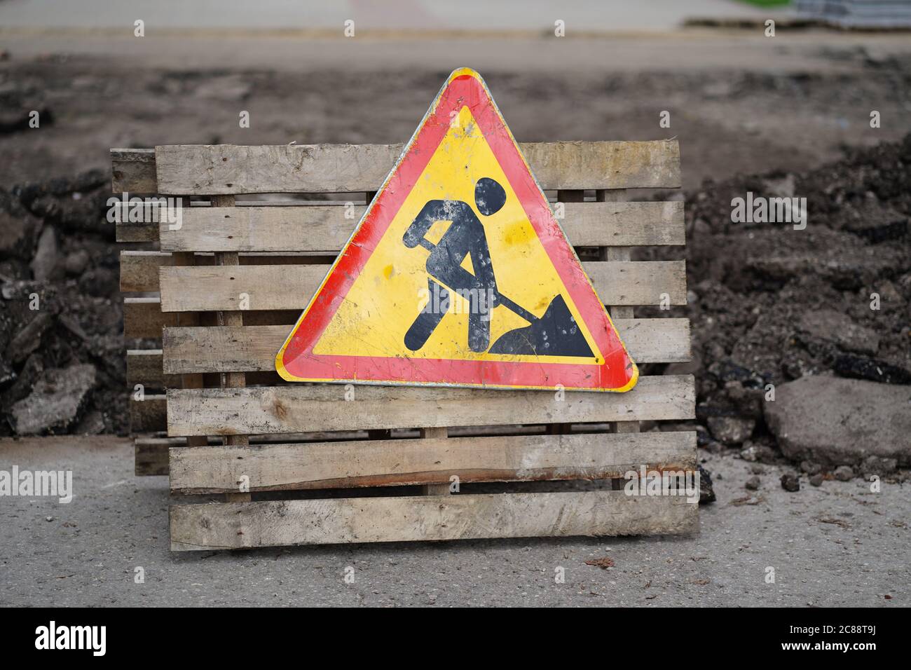 Sign of road work to inform traffic participants about carrying out repairs on road. Concept of careful and attentive driving. Stock Photo