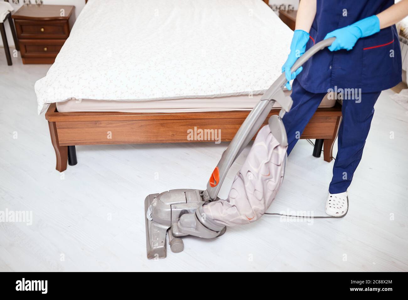 Staff in Uniform Cleaning Bed Sheets in Washing Machine Editorial Image -  Image of beautiful, cleaning: 132050685