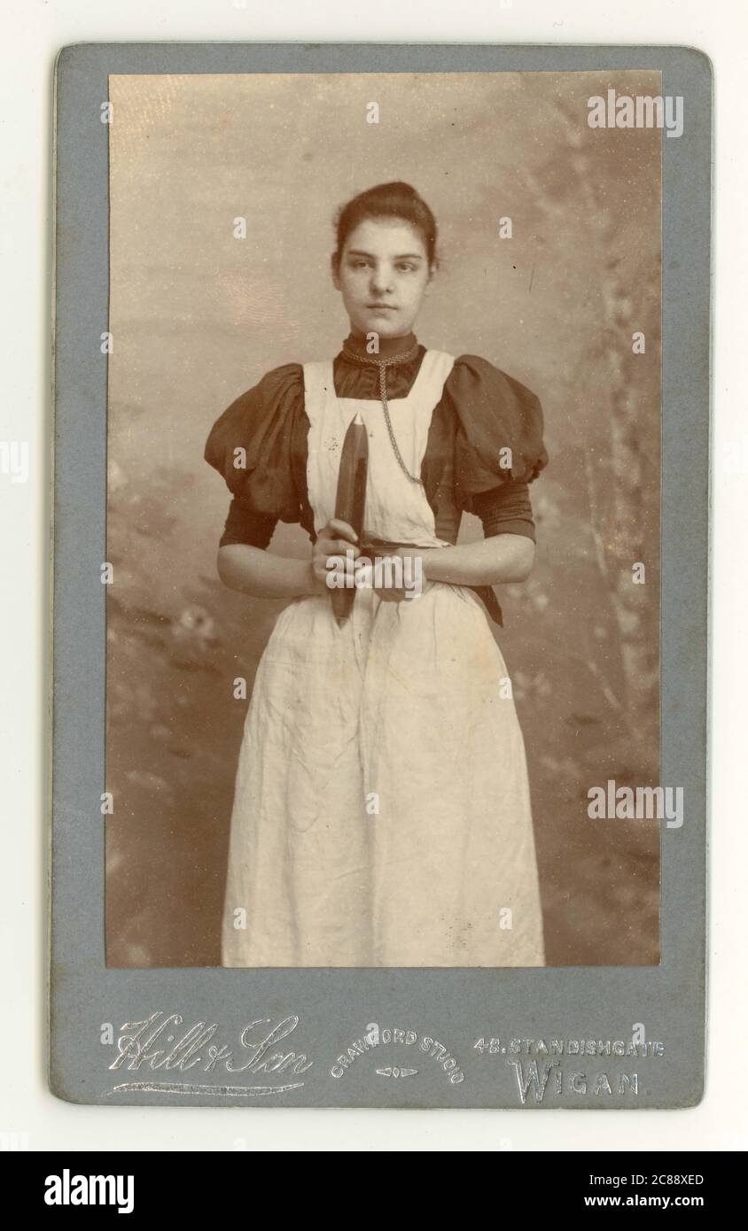 Original Victorian Carte de Visite (CDV) of attractive young cotton spinner girl, holding a weaver's shuttle, Standishgate, Wigan, Lancashire, England,  U.K. circa 1894 Stock Photo