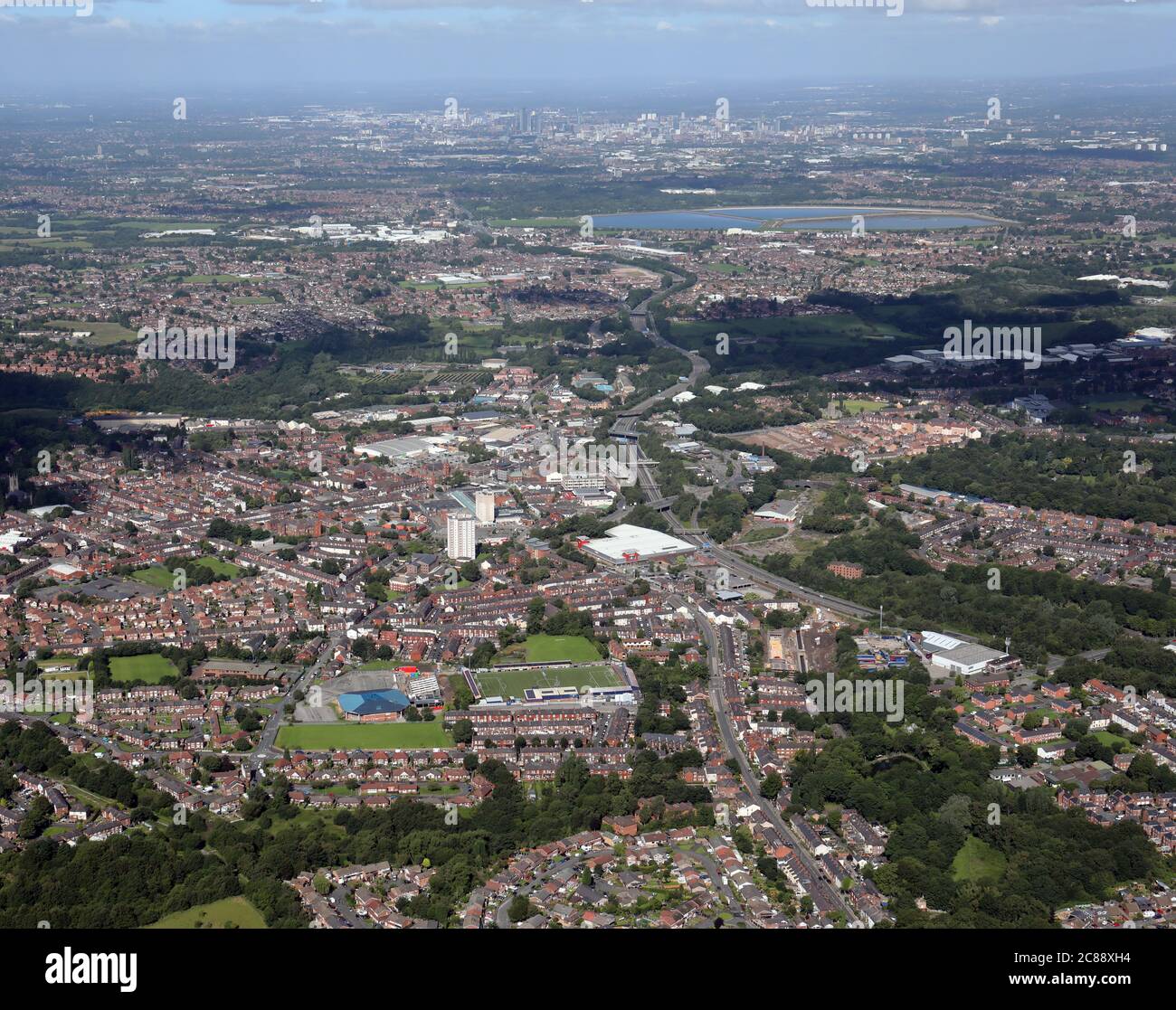 aerial view of Hyde from the east with the Football Club and Leisure Centre prominent in the foreground Stock Photo