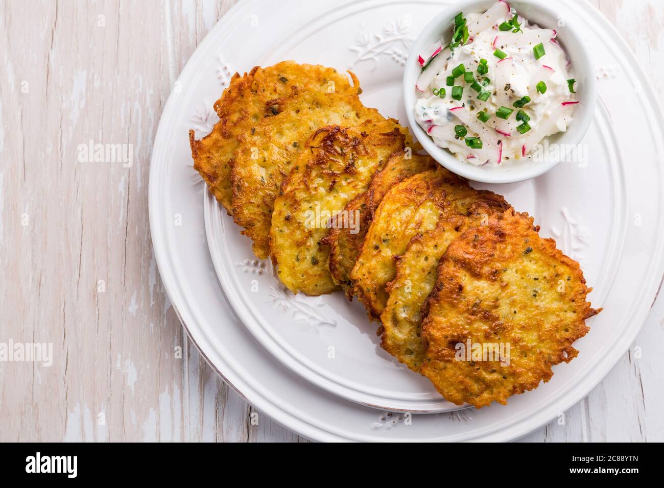 Fried potato  pancake with radishes cream cheese and chives. Vegetarian food concept, Stock Photo