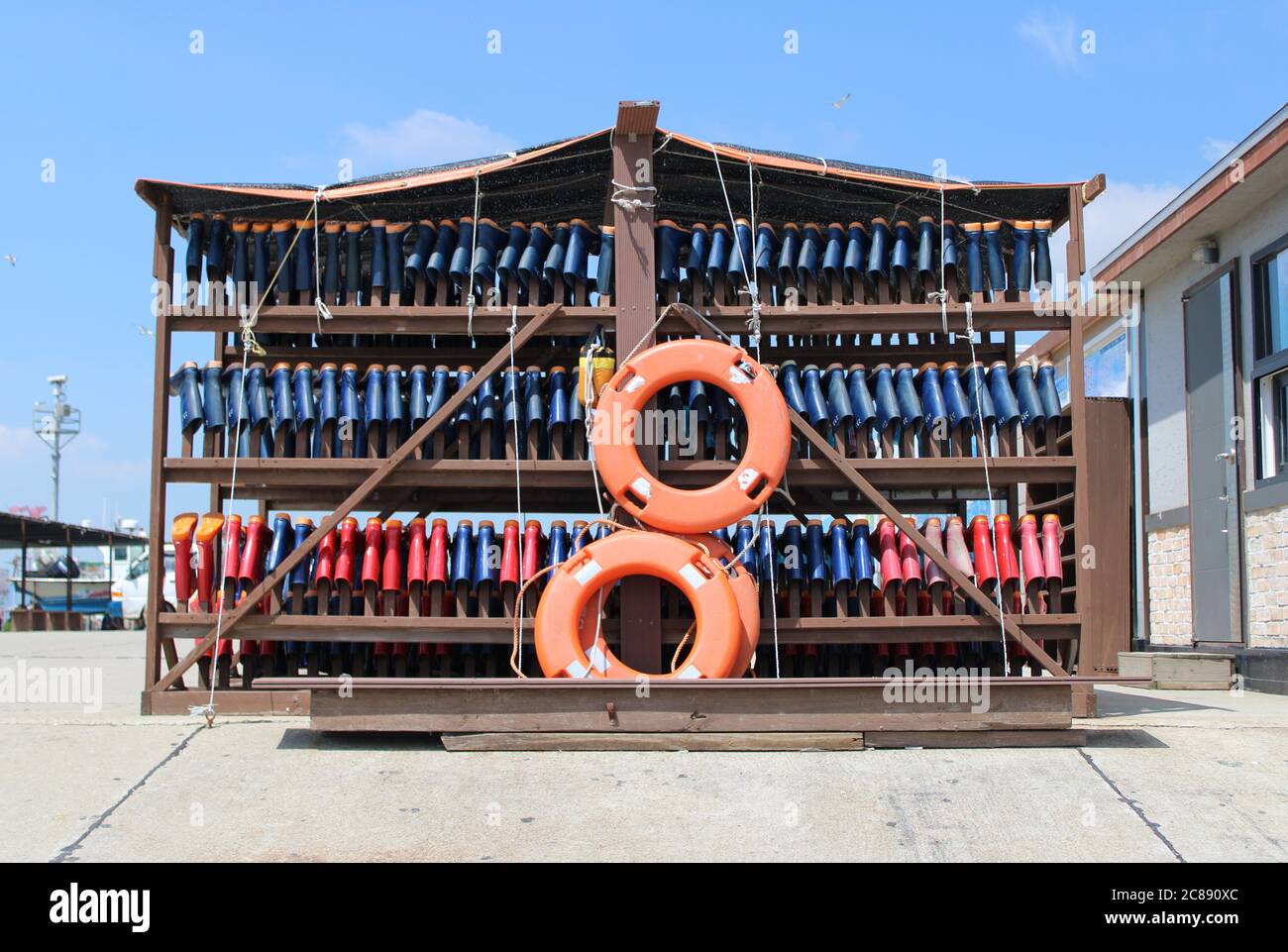 Rubber boot rental shack with bright orange lifesavers, near a clam digging area Stock Photo