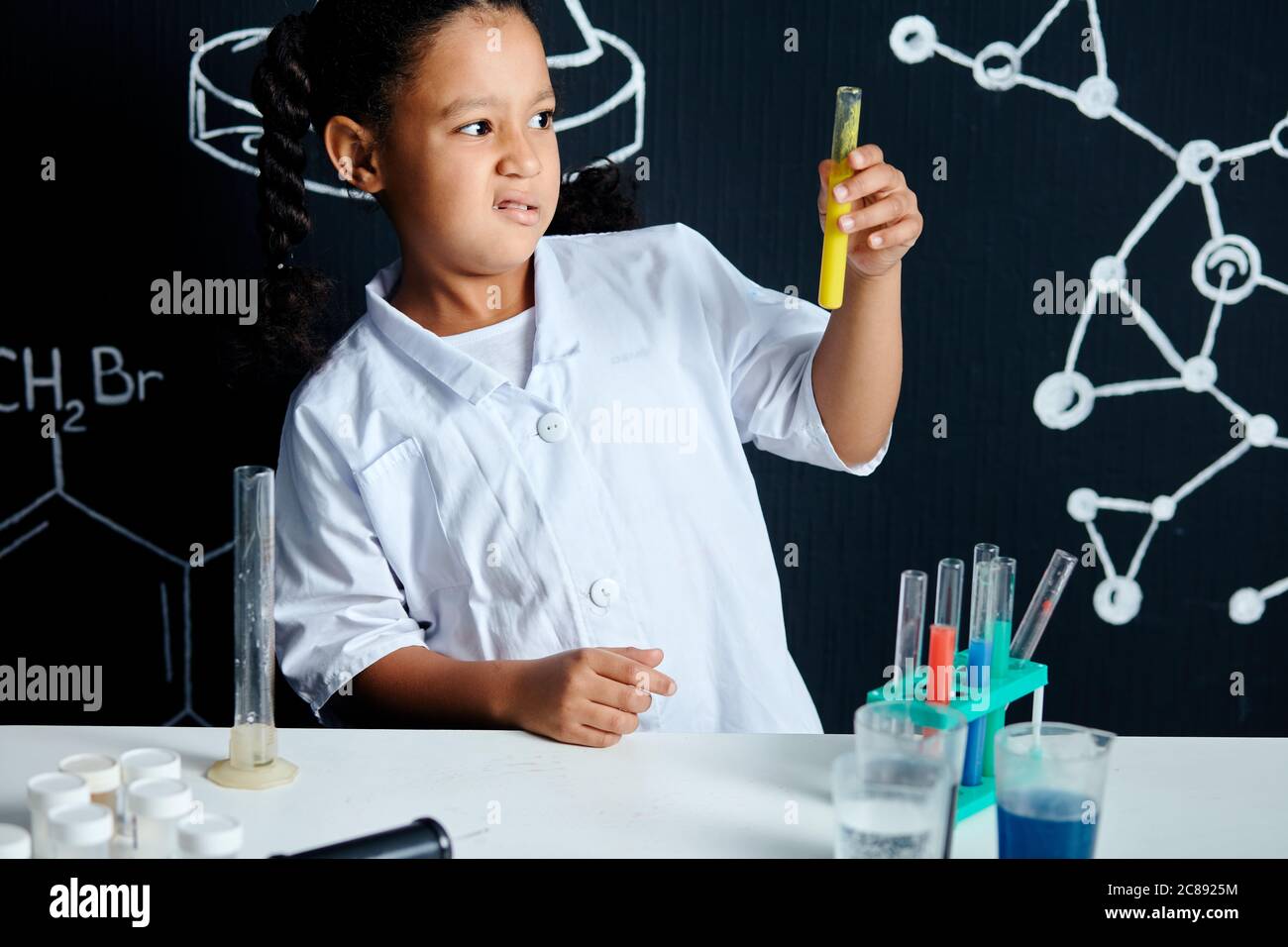 Mixed race asian little girl wearing white lab coat and protective