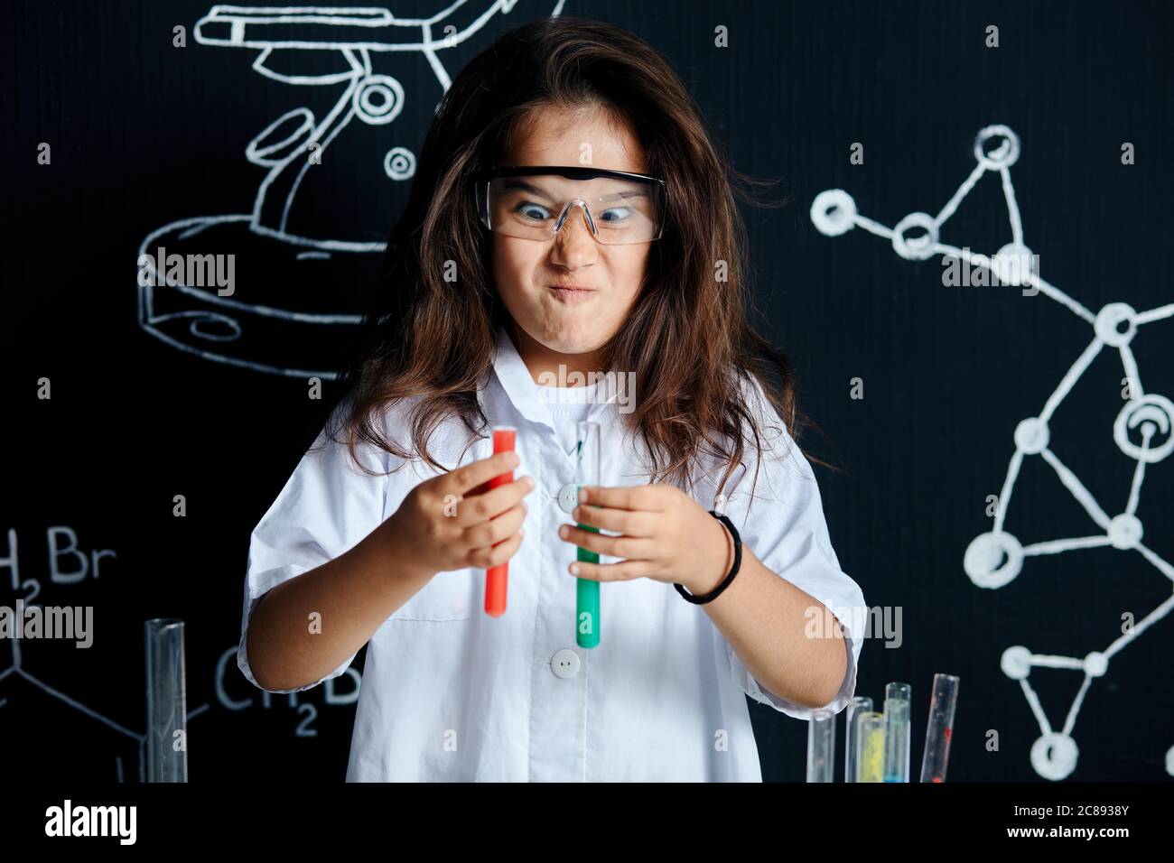 Mixed race asian little girl wearing white lab coat and protective