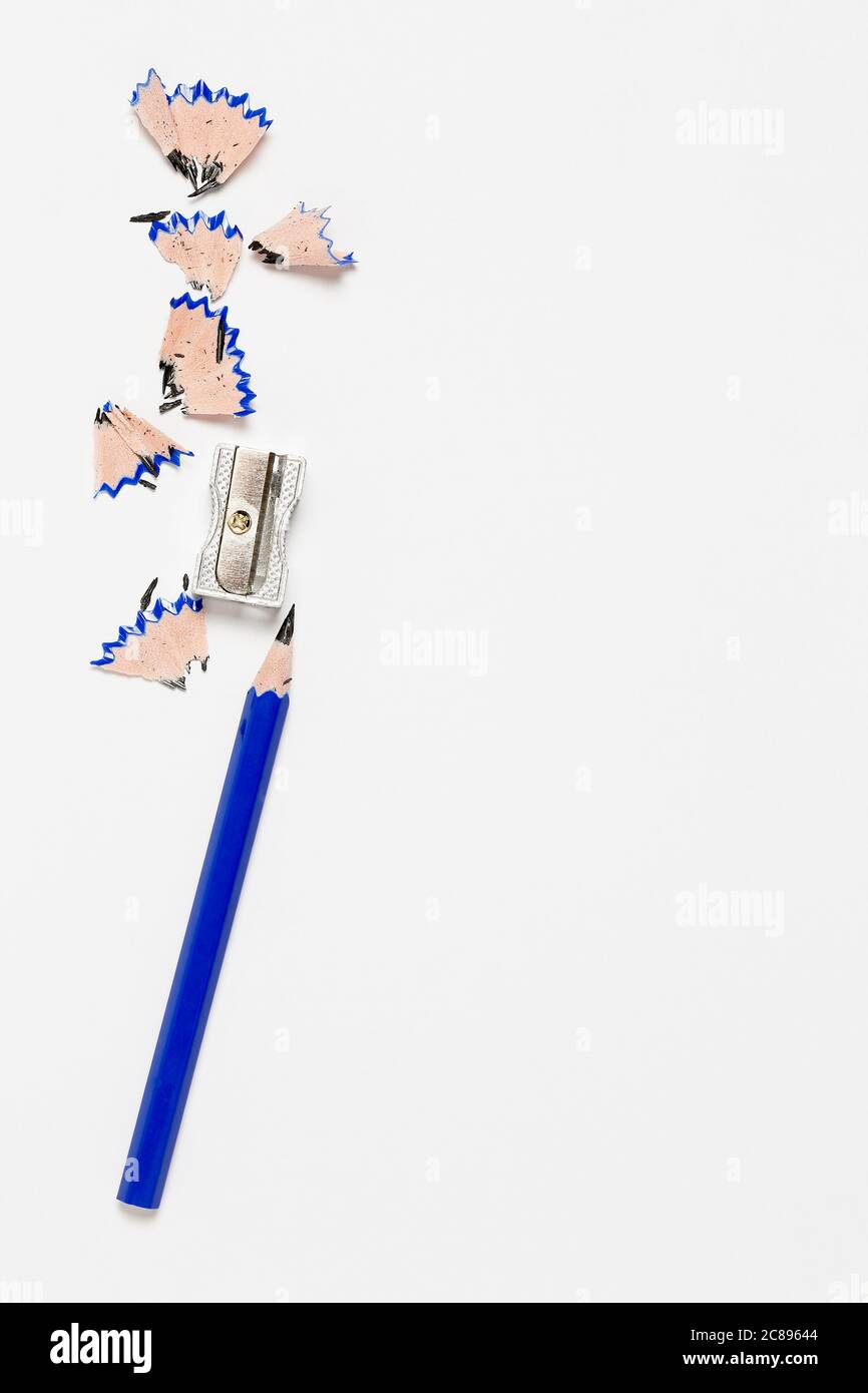 pencil and sharpener on blank paper surface Stock Photo