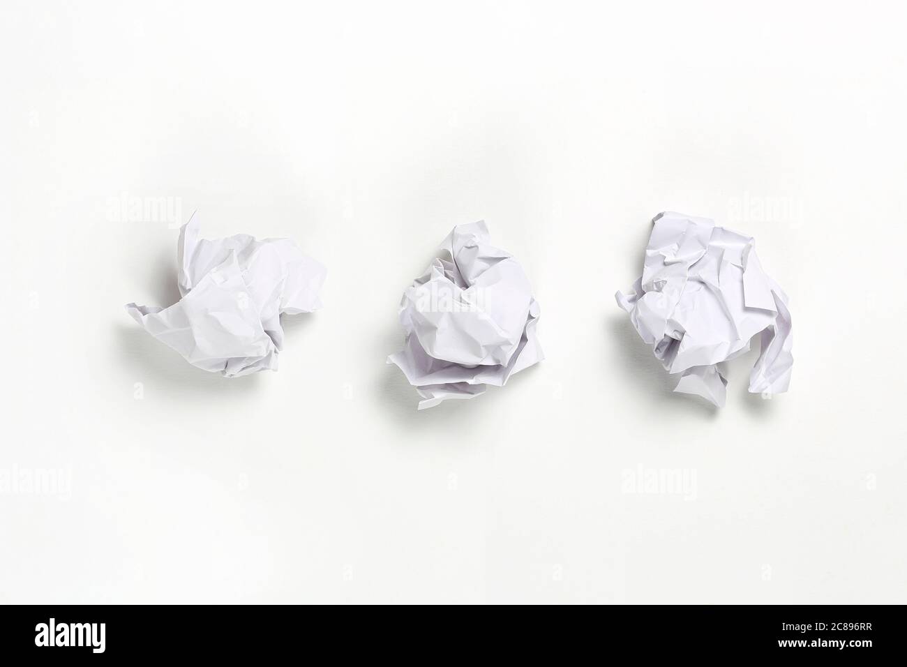 white crumpled paper balls on white surface Stock Photo
