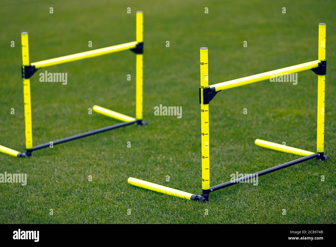 Yellow Training Hurdles on Sports Training Field. Two Hurdles in Line For Jumping Practice