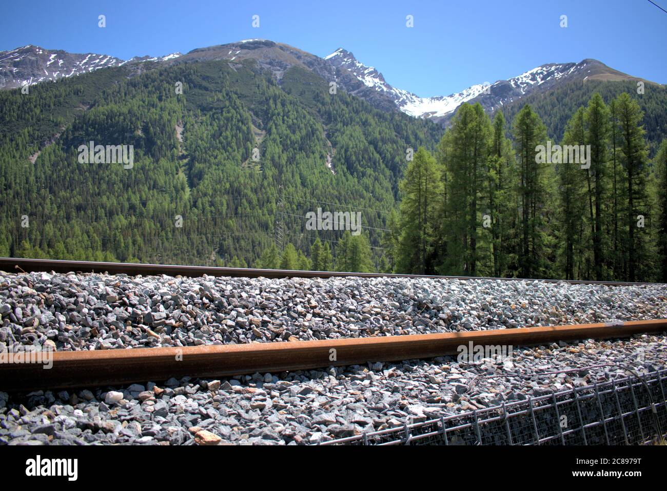 Railway track in Engadine in the swiss mountains Stock Photo