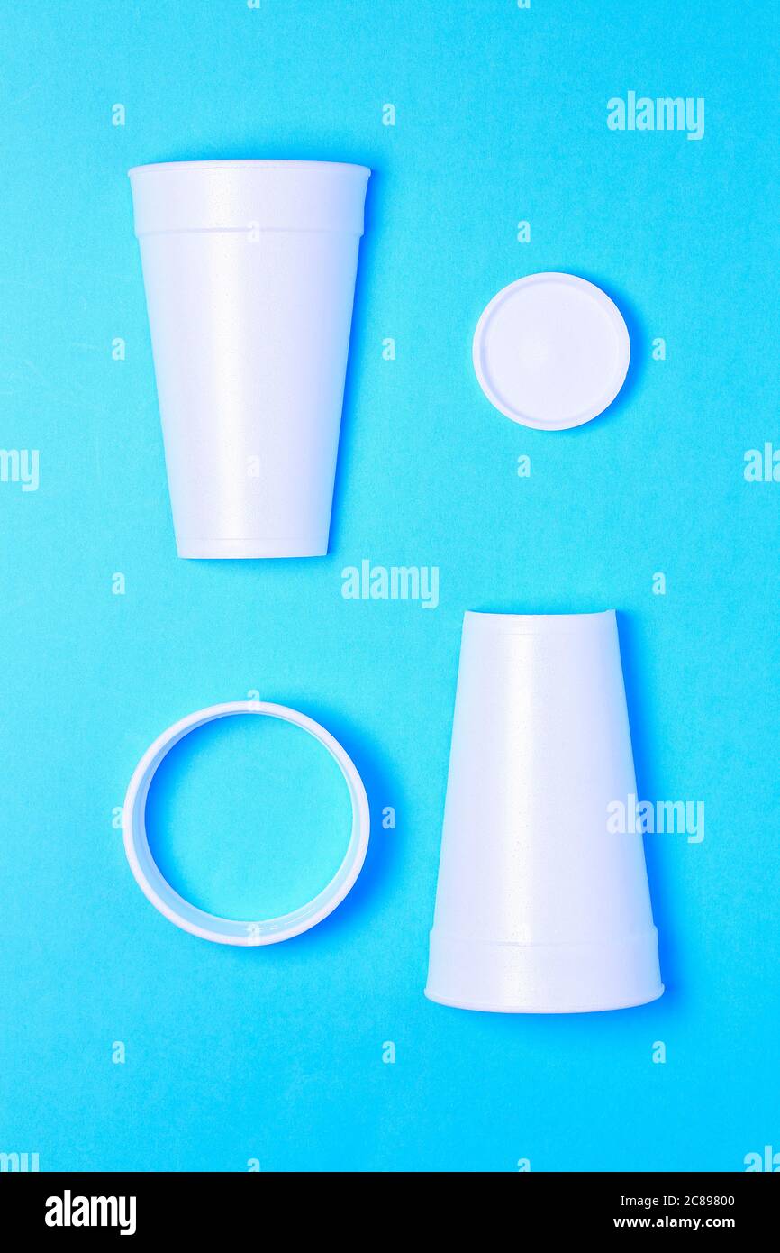 foam cup cut in four pieces on blue paper Stock Photo Alamy