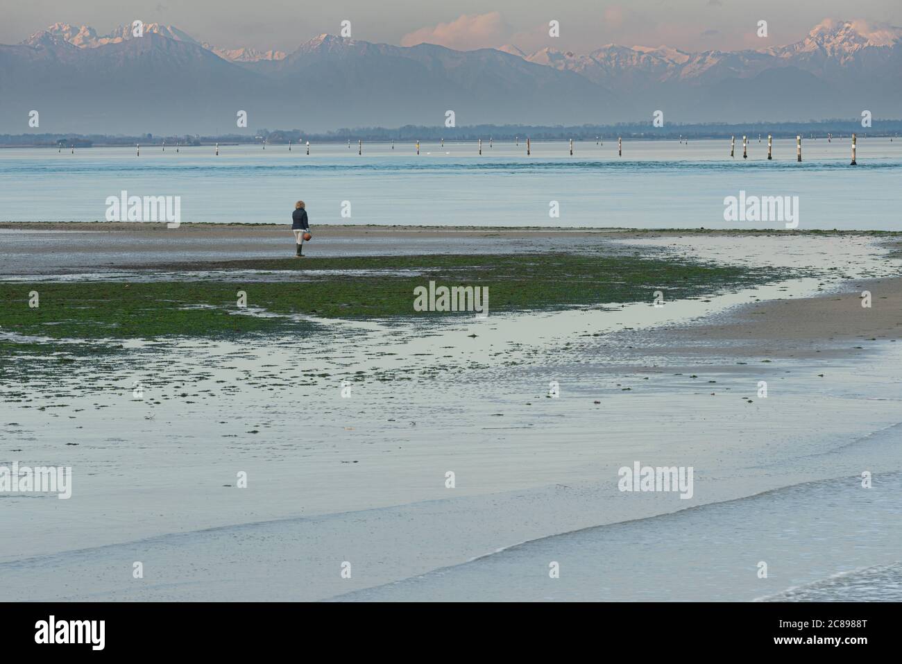 Lignano Sabbiadoro lagoon with Julian alps in background. Italian marine landscape. Friuli Venezia Giulia region, Italy. Stock Photo