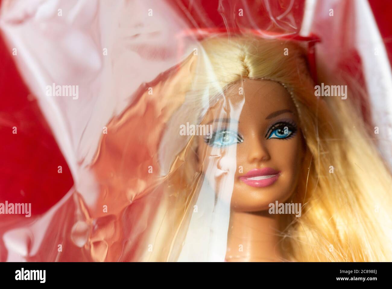 Close-up of a Barbie Doll Face Covered with Plastic Stock Photo