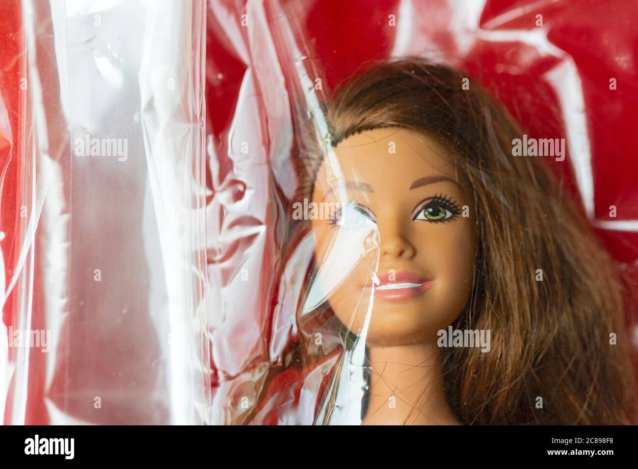 Close-up of a Barbie Doll Face Covered with Plastic Stock Photo