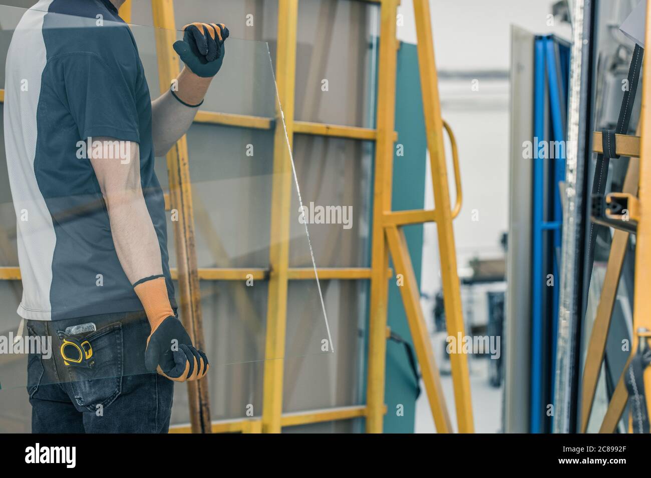 Glass factory, Worker carrying glass panes Stock Photo Alamy