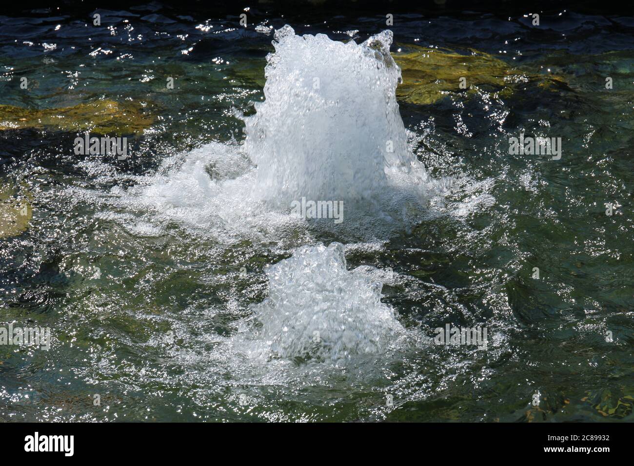 Close up of a waterfountain feature with water bubbling up at a park in Illinois, USA Stock Photo
