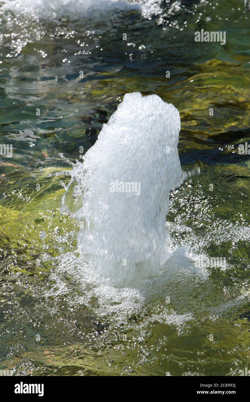 Close up of a waterfountain feature with water bubbling up at a park in Illinois, USA Stock Photo