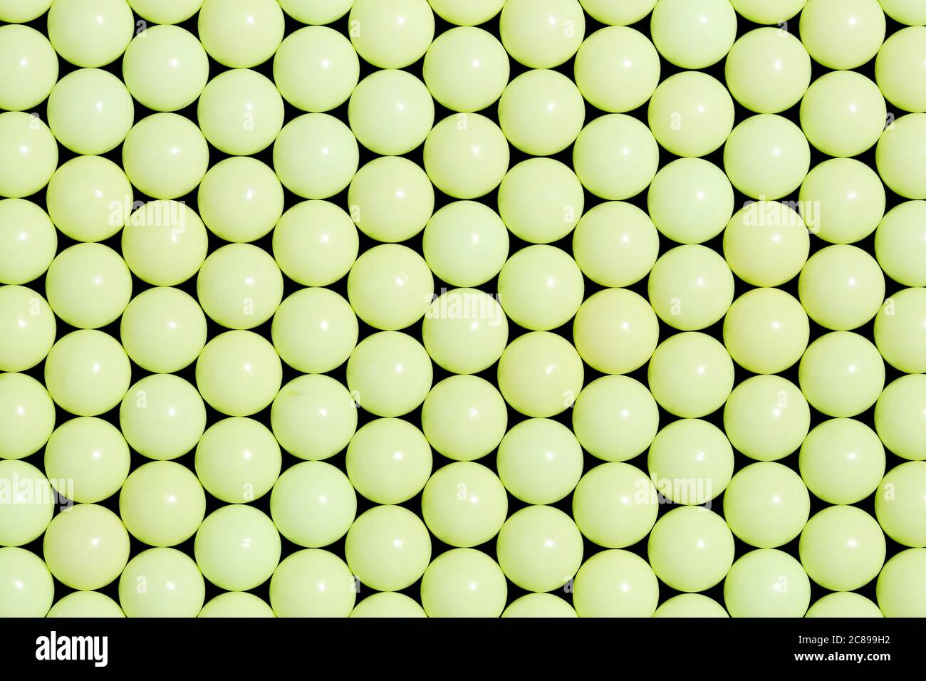 many yellow plastic balls closeup for backgrounds, abstract pattern