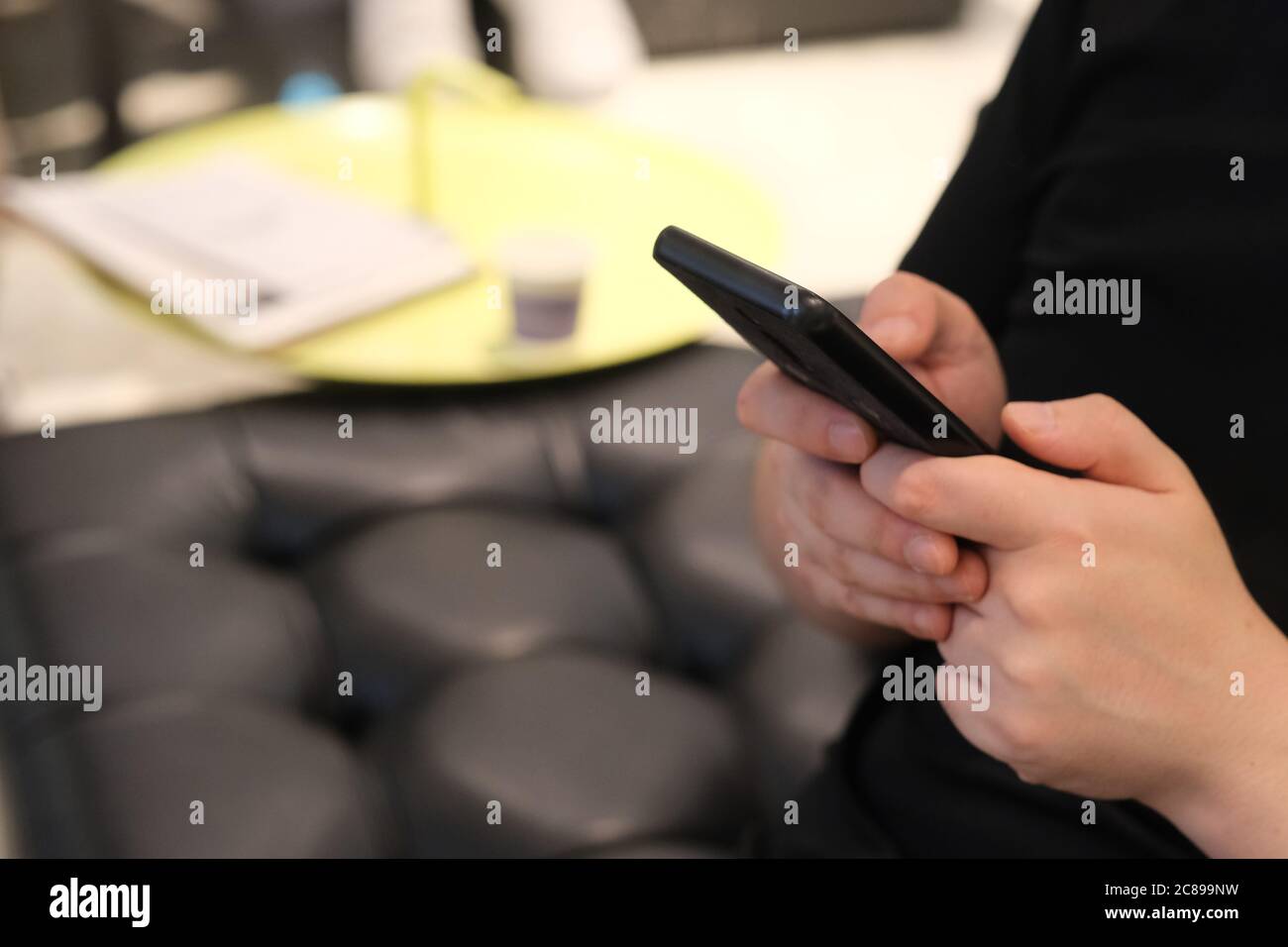 close up hands using smart phone indoor. blur background Stock Photo
