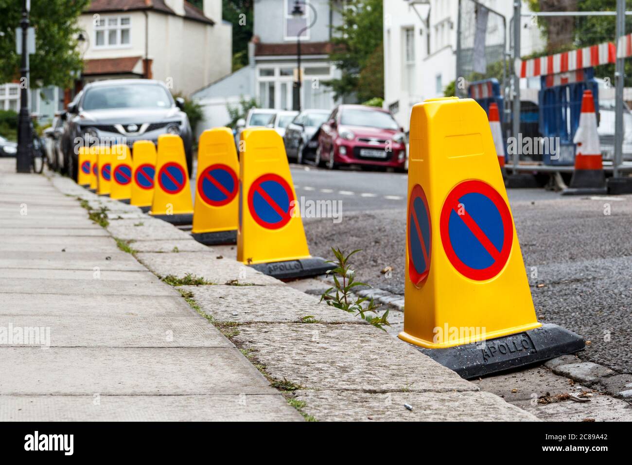 Low viewpoint image of no parking cones by the side of a residential road due to roadworks, London, UK Stock Photo
