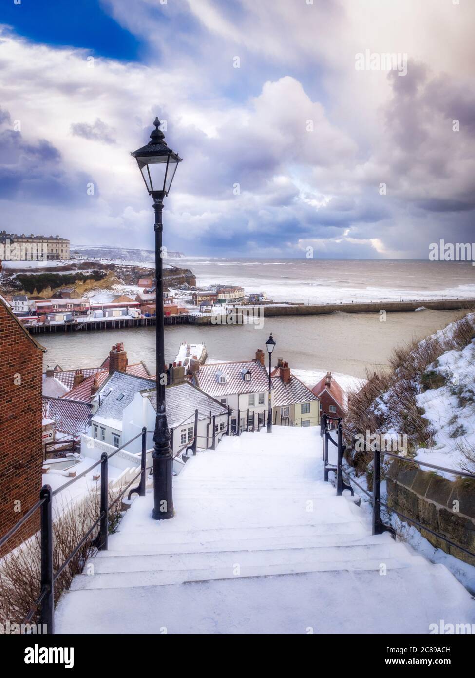 Snow covered steps leading down from St Mary's Church, Whitby, North Yorkshire, UK Stock Photo