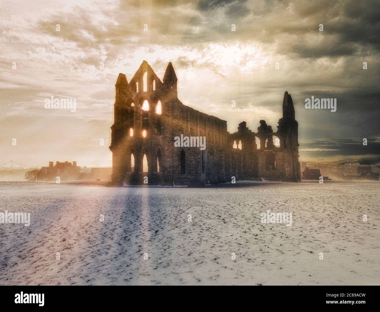 Whitby Abbey at sunset in snow, North Yorkshire, UK Stock Photo