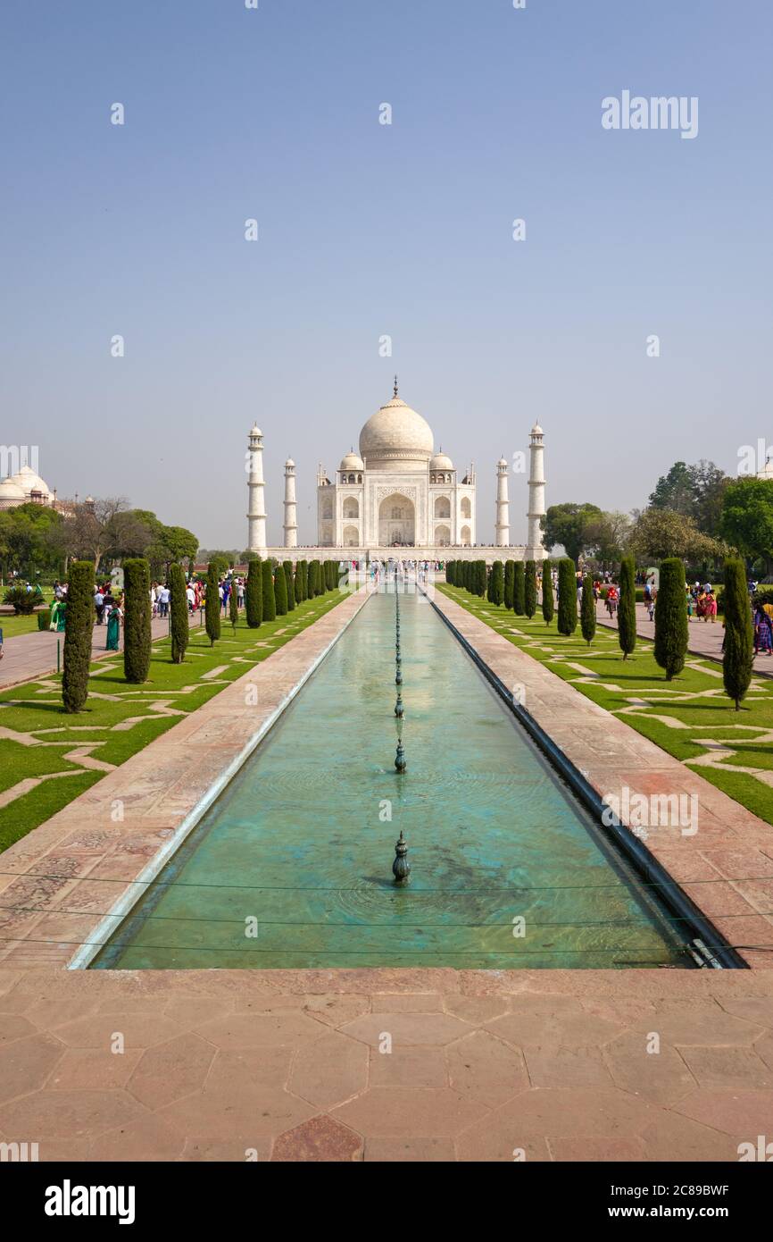 Vertical picture of Taj Mahal on sunny April day, with walkways and water in the foreground Stock Photo