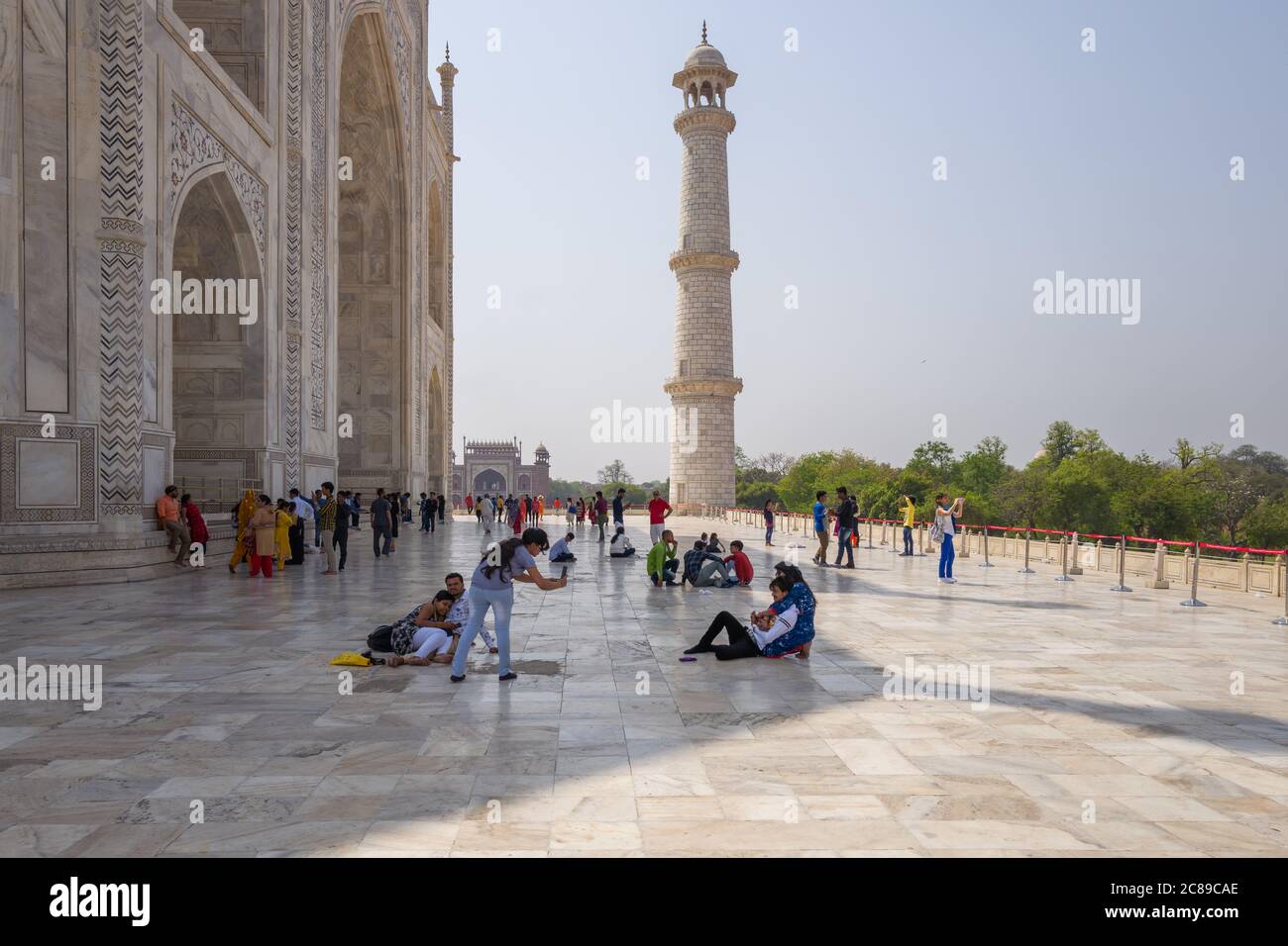 The exterior of the Taj Mahal, India - with visitors between the main building and one of the four minarets, some taking photographs Stock Photo