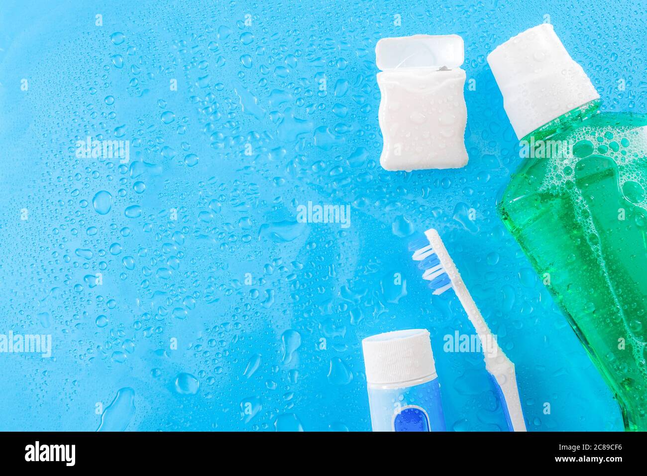 Toothpaste Water Dental care and oral hygiene concept with a bottle of green mouthwash ...