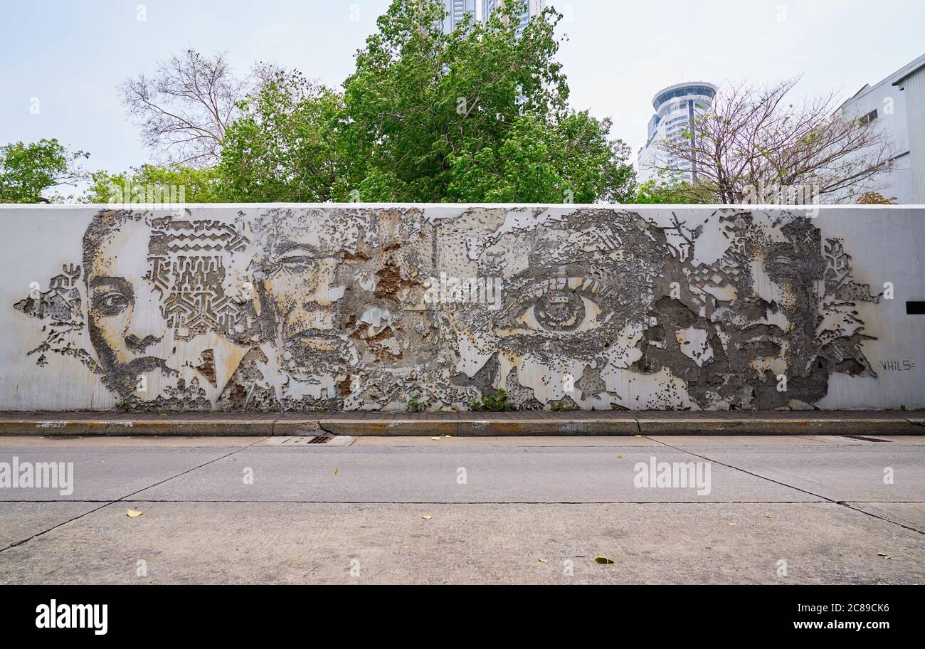 Portuguese artist Alexandre Farto created this art work on the wall of the Portuguese Embassy in Bangok his artist name is Vhils Stock Photo