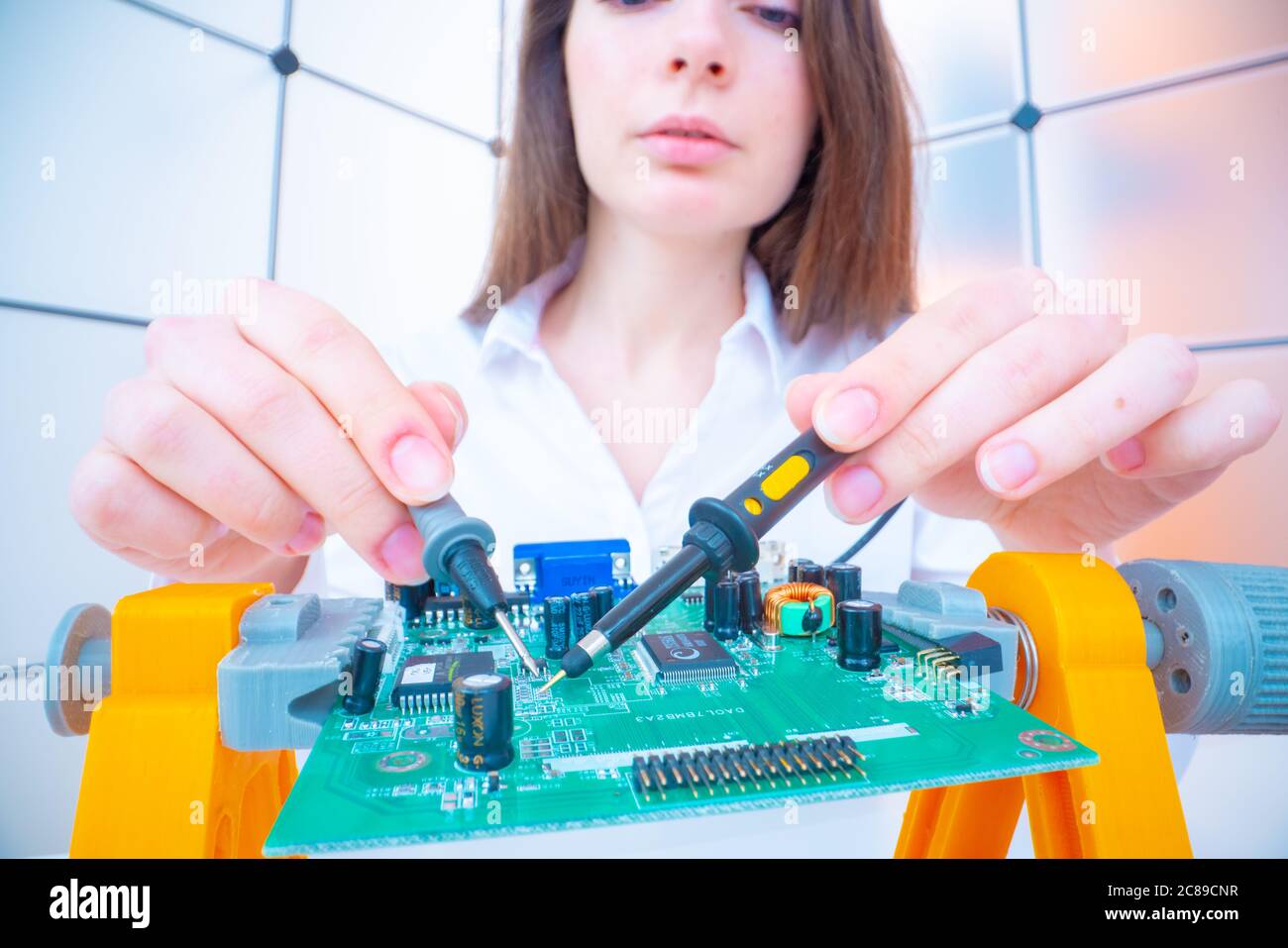 Young woman with measuring devices in the electronics engineer  laboratory Stock Photo