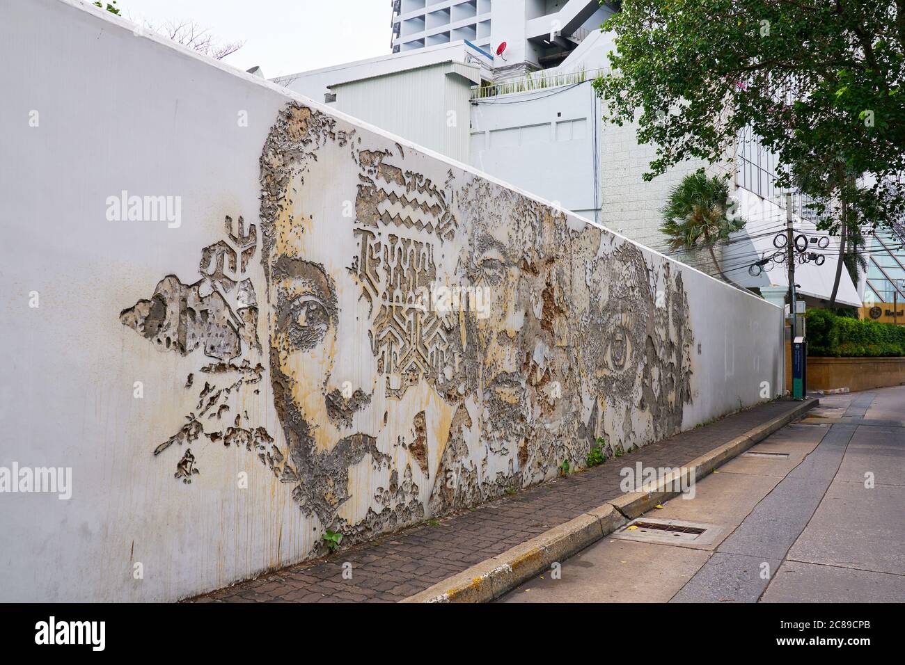 Portuguese artist Alexandre Farto created this art work on the wall of the Portuguese Embassy in Bangok his artist name is Vhils Stock Photo