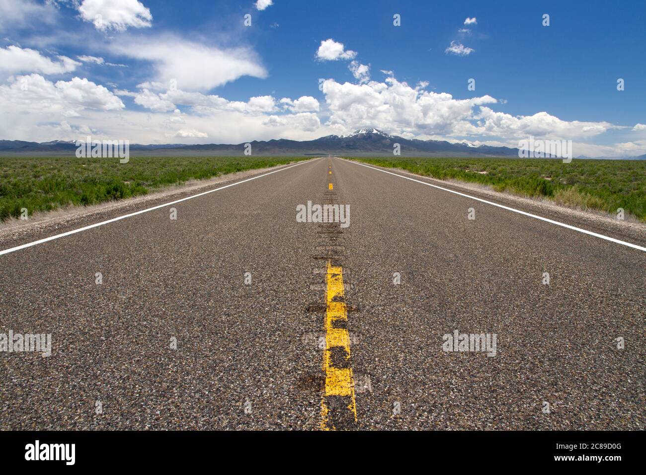 Low perspective view looking down the middle on highway 93 in the Basin and Range country of Nevada Stock Photo