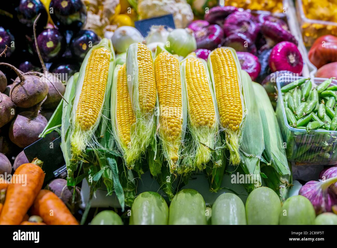 Corn on the cob. Farmers market with fruits and vegetables, open shelves showcases. Healthy organic food. Autumn harvest Stock Photo