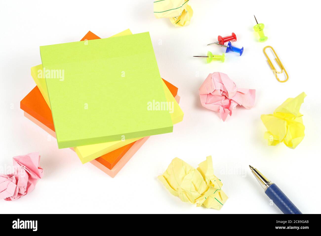 adhesive notes with pins and pen on white surface Stock Photo